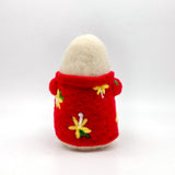 Image from the back of a hand felted small white ghost in a red Hawaiian style shirt holding a coconut cocktail