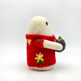 Image from the side of a small hand felted white ghost in a red Hawaiian style shirt holding a coconut cocktail