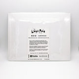 The white back side of the unique art print that includes an information card about Leroy's Place