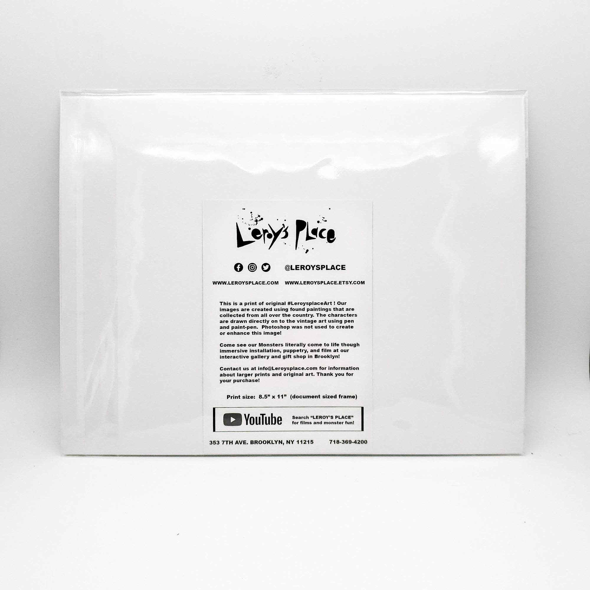 The white back side of the unique art print that includes an information card about Leroy's Place